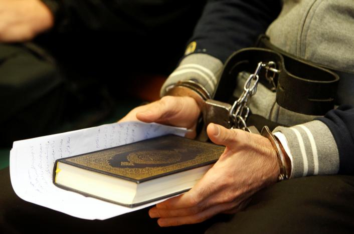 Syrian-Cypriot Ahmed Hamed, 40, holds a copy of the Holy Koran as he listens to a judge sentence him to 10 years in jail for his part in a 2015 riot at Hungary's Serbian border, in Szeged, Hungary, on November 30, 2016. Reuters/Bernadett Szabo